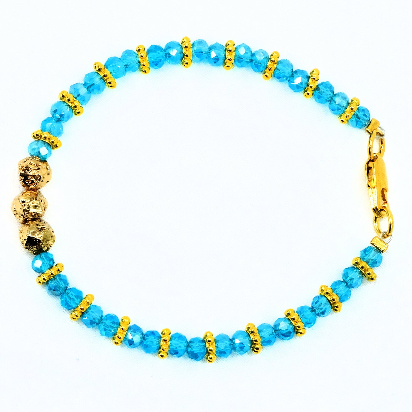 6mm Light Blue Glass Crystal with gold main beads and spacer beads, beaded bracelet. Gold clasp.