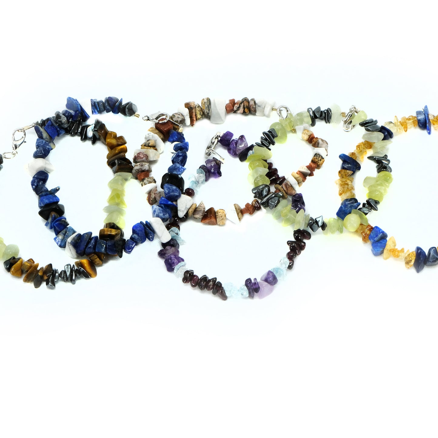Chipped semiprecious beaded bracelet. Silver clasp. Tigereye, garnet, amethyst, topaz, lapis, aquamarine, agate, howlite, goldstone